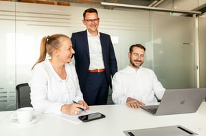 Drie collega's in overleg aan een vergadertafel over de WGA-premie en de instroom in de WGA